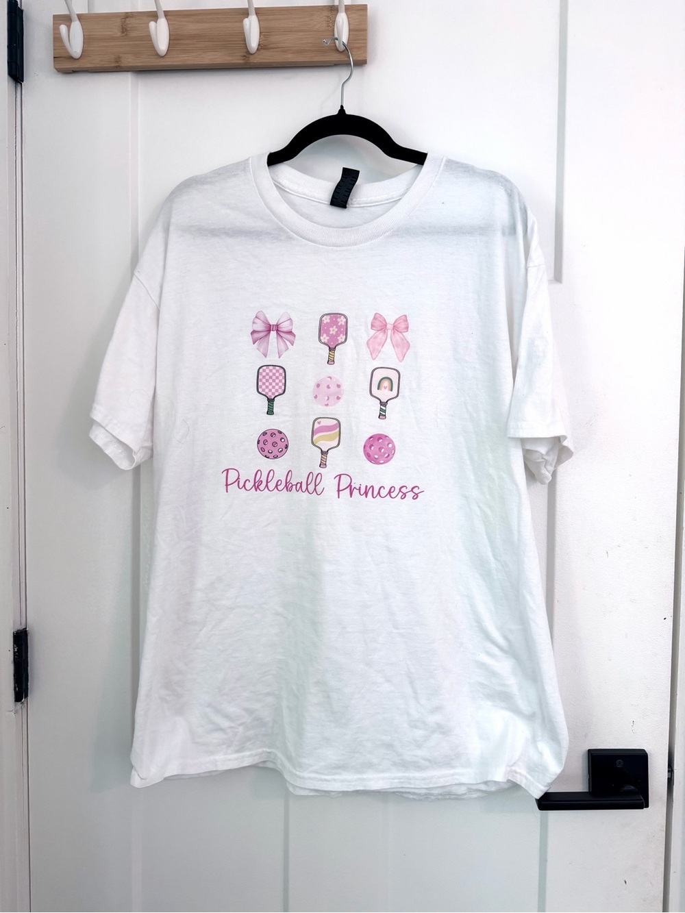 White Gildan "Pickleball Princess" cotton t-shirt with pink pickleball equipment